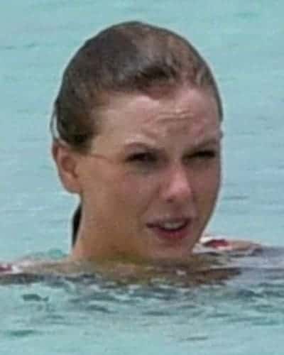 Taylor Swift is swimming at the beach