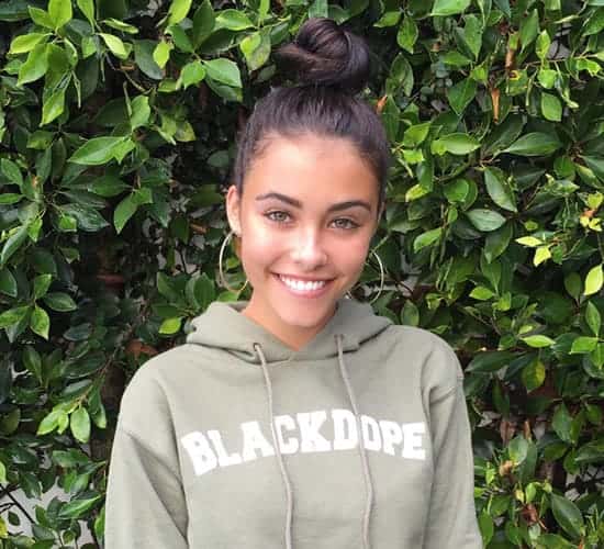 Madison Beer with leafy background