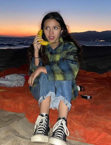 Olivia Rodrigo calling someone with a banana
